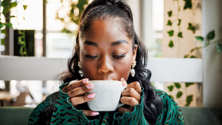 woman drinking a cup of coffee