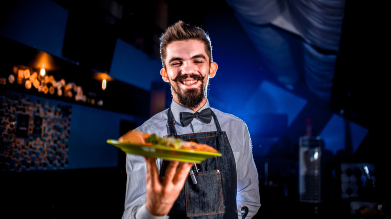 a waiter serves a meal at a restaurant