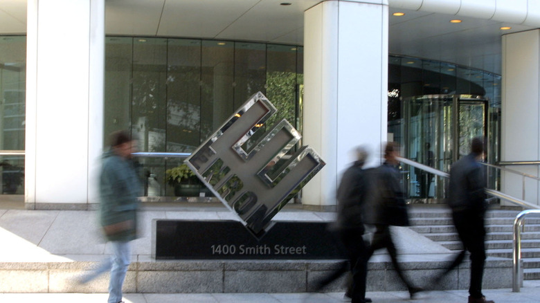 people walk past Enron building