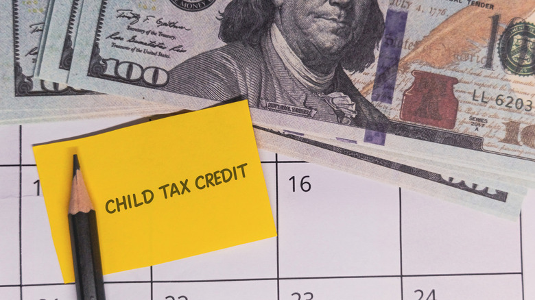 "Child Tax Credit" note on calendar with US currency and pencil.