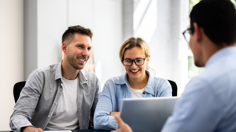 Financial planner meets with clients.