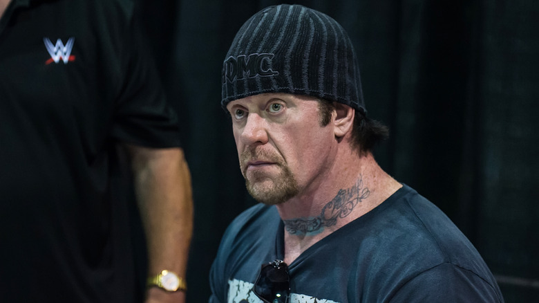 The Undertaker signing autographs for fans