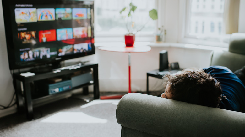 Person selecting a show while watching a streaming service