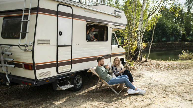 A family enjoying an RV at a campsite