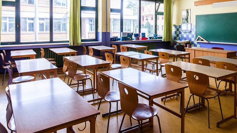 Empty classroom with empty chalkboard