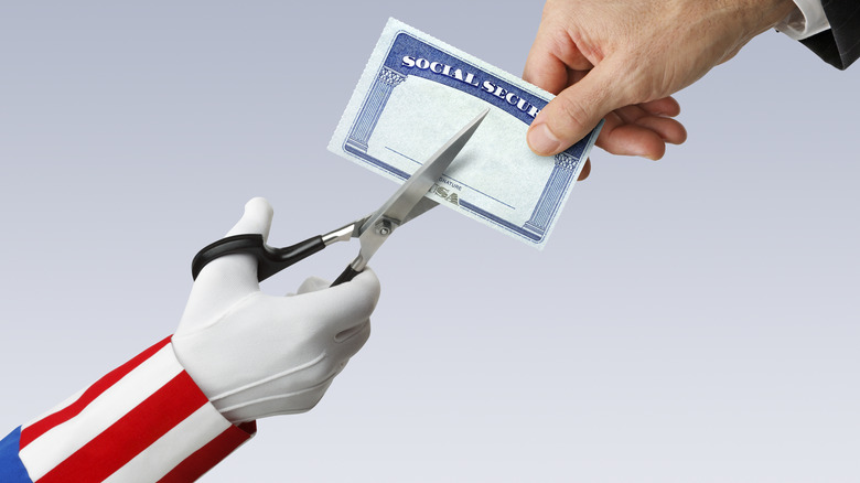A Social Security card is being cut by Uncle Sam