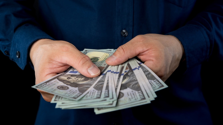 Close up of a man counting money in his hand
