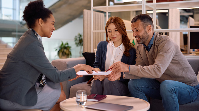 couple speaking to a real estate agent