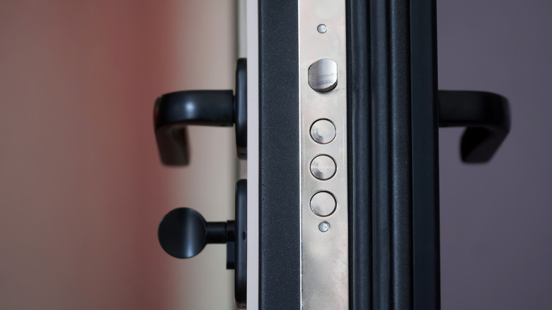 Image of lever-style door handles on either side of a door