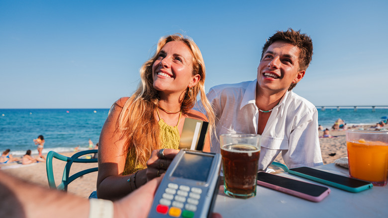 photo of rick steves holding a microphone speaking at an event