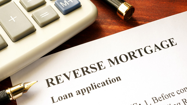Reverse mortgage application with calculator and pen
