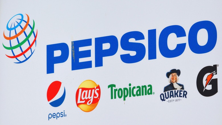 A PepsiCo sign showing Tropicana label among other brands