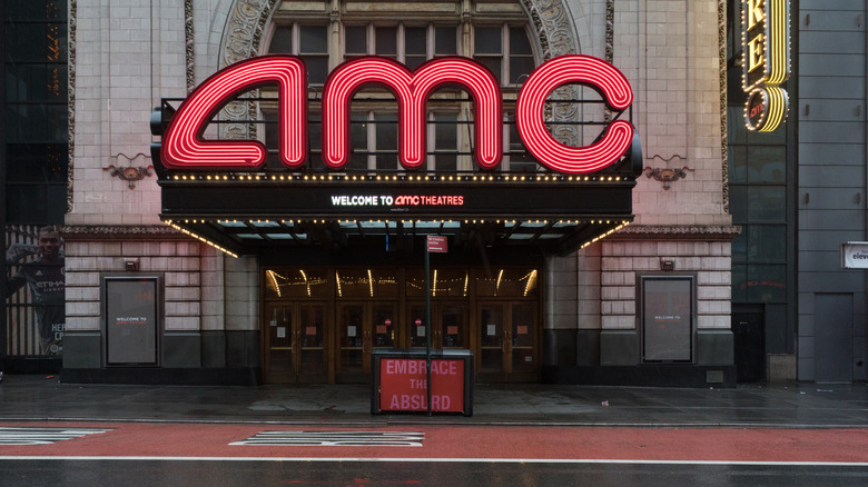 Neon sign for AMC in front of movie theater