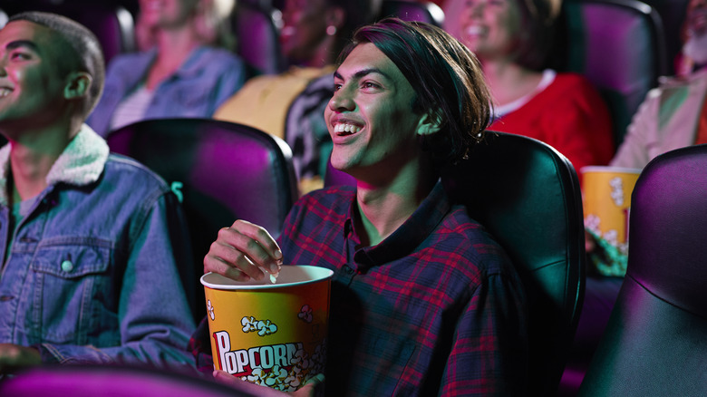 Person eating popcorn inside a movie theater