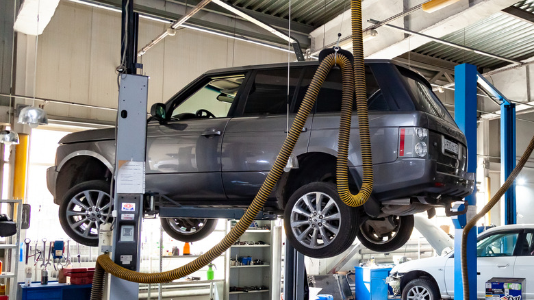 a Range Rover lifted up in an auto repair shop