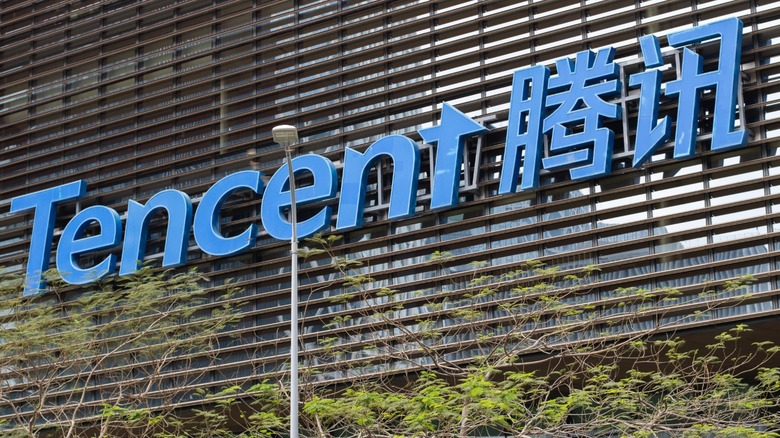 Blue "Tencent" logo written in English and Mandarin on the side of a building