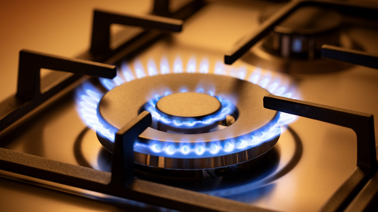 A gas stove burner turned on.