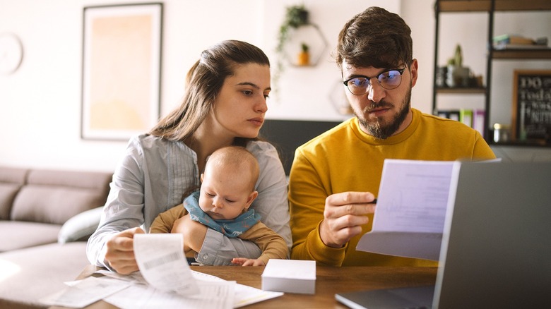 Family with baby reviewing paperwork