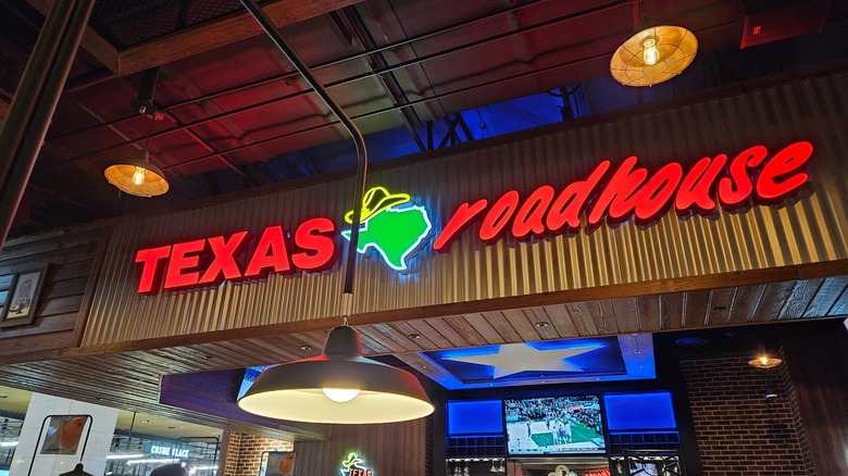 shot of inside of a Texas Roadhouse with sign lit up