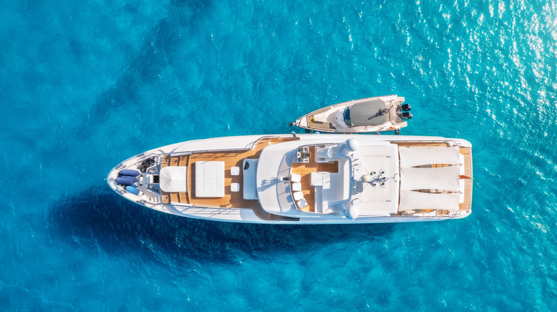 Aerial view of beautiful luxury yacht and boat in blue sea in summer.