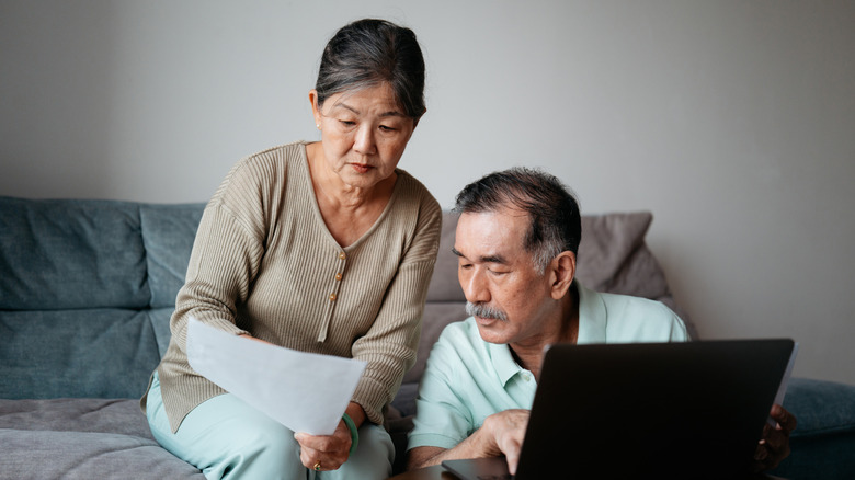 Retired couple looking at bills together