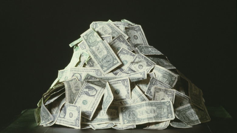 An old photo of a pile of one dollar bills.