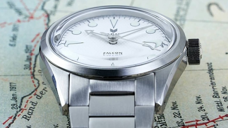 The Lorier Falcon in silver sits on a map
