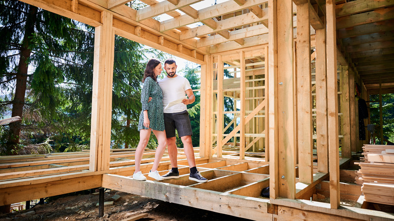 Family walking through framed out home