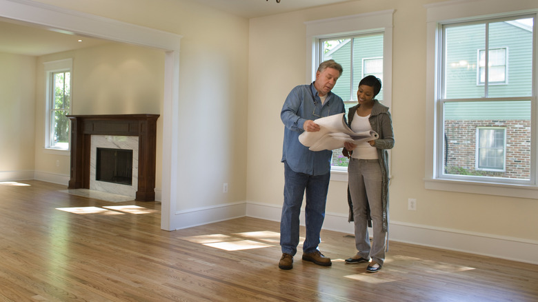 A young homeowner looking over paperwork with an inspector