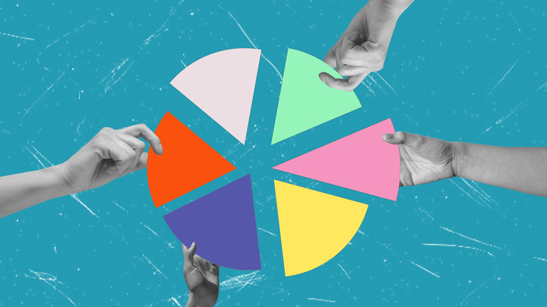 hands holding parts of a pie chart