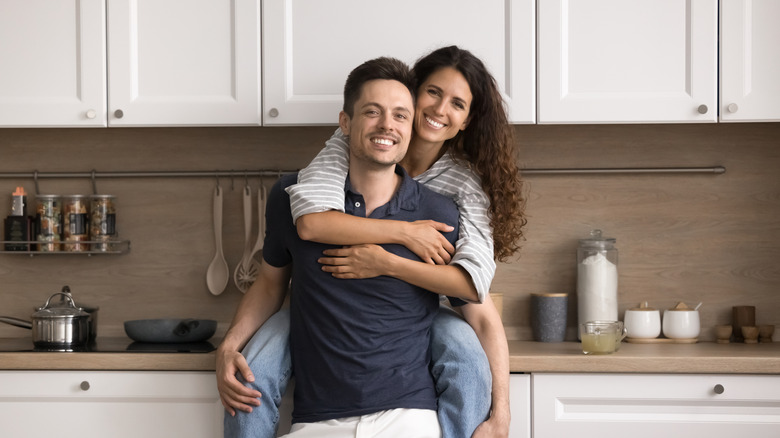 happy millennial couple in a kitchen