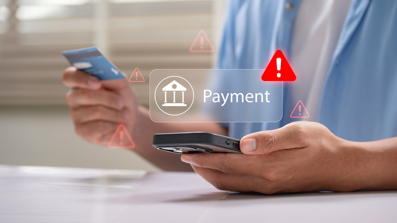 A person using a credit card and smartphone for digital banking