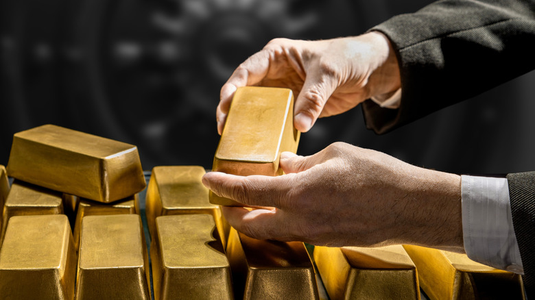 A banker handling gold bars