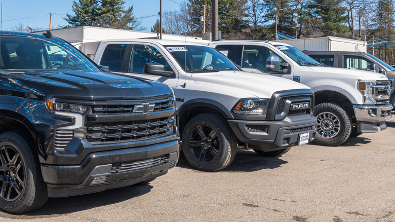 pre-owned pickup trucks on a dealership lot