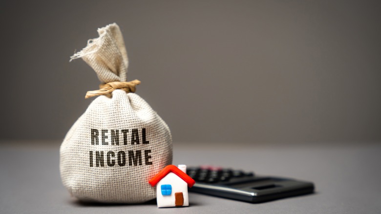 rental income burlap sack and a house figure