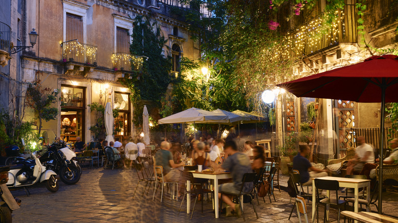 European street with cafe at evening