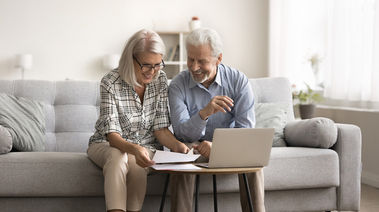 A happy older couple using a computer