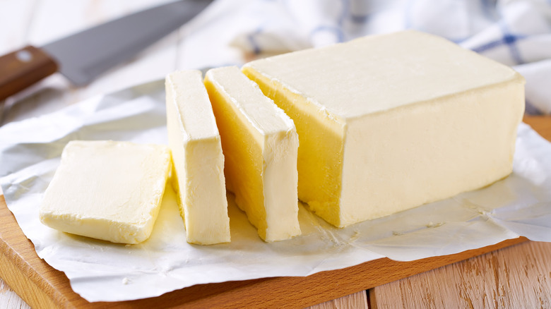 Sliced butter on a woodern cutting board
