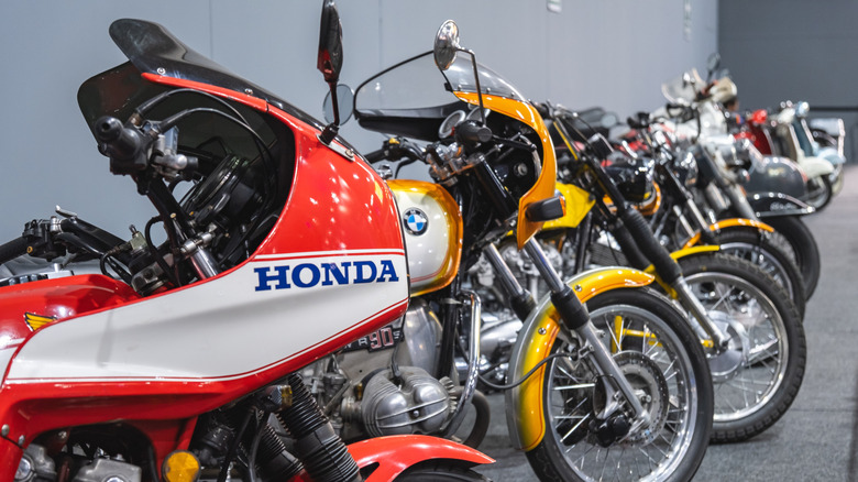 line up of different motorcycles with Honda and BMW models in front