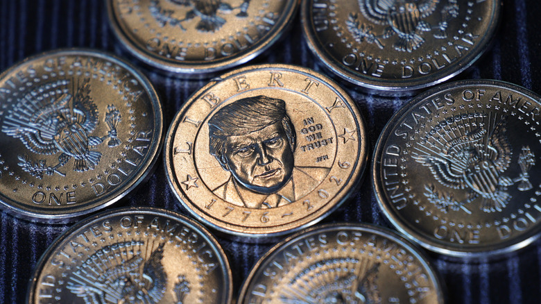 Multiple Trump $1 coins lying on a surface