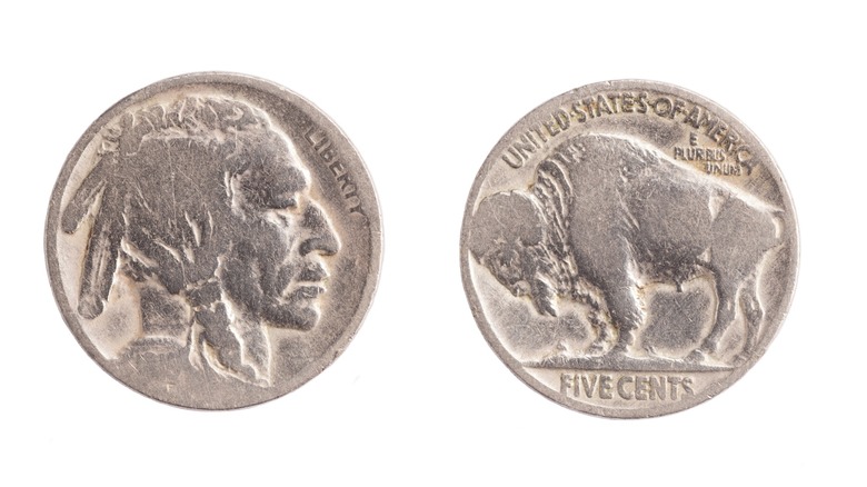 Both sides of a silver buffalo nickel showing a Indian head on the left and Buffalo on the right