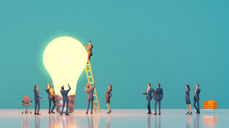 people figurines arounda lightbulb