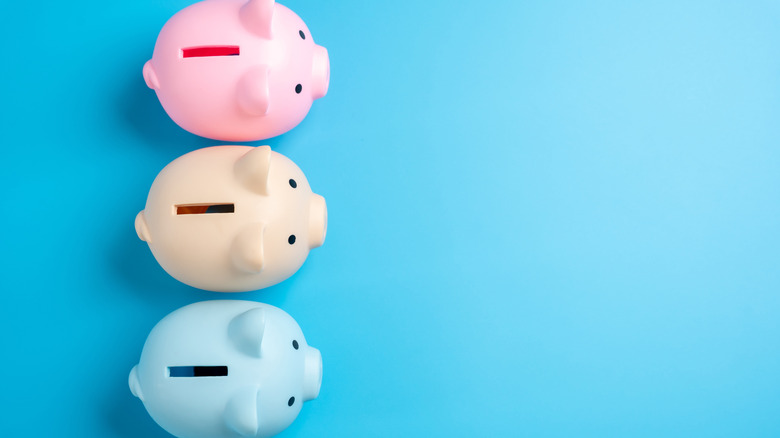 three piggy banks in different colors