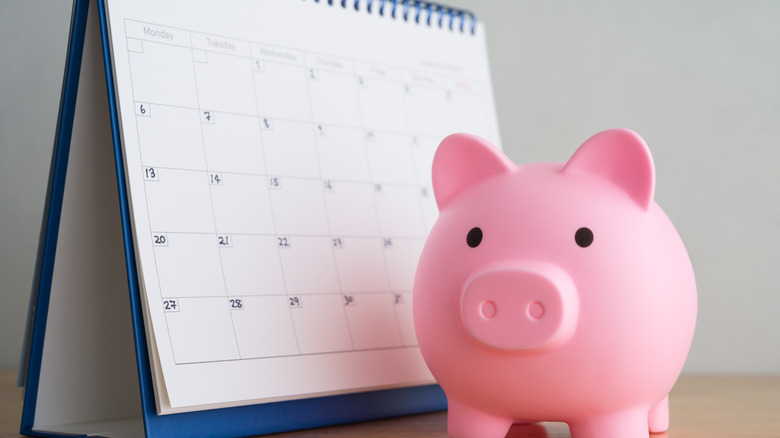 piggy bank next to calendar