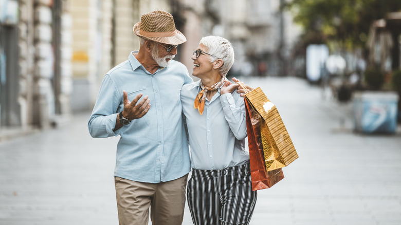 senior couple shopping with bags