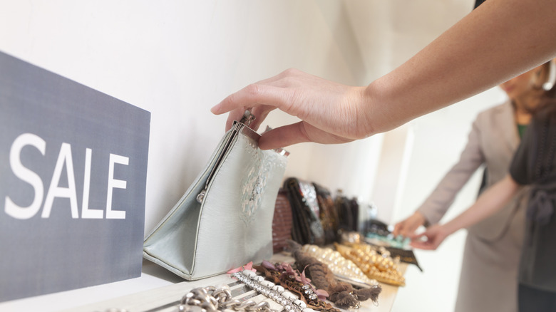 sale sign next to merchandise