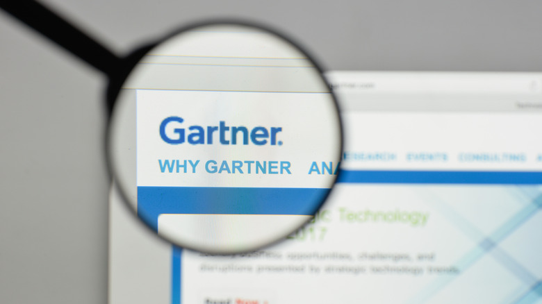 A magnifying glass over the Gartner website logo on a desktop screen