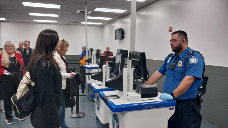 airport travelers being screened with Leidos equipment