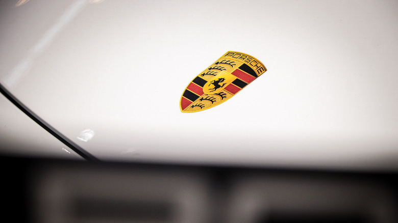 Porsche logo on hood of car