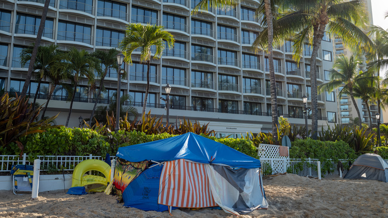 Tent on the beach beneath palm trees